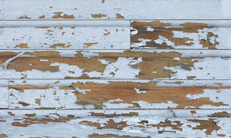 Old lead paint peeling off of wood siding on a Portland OR home