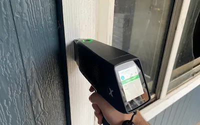 An Atlas Labs technician scanning a window frame for lead testing