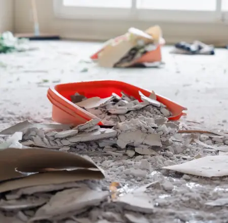 paint and drywall pieces in dust bin