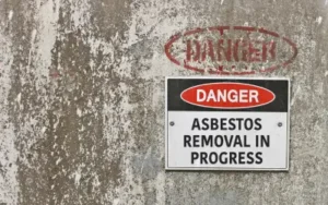 sign cautioning that asbestos removal is in progress