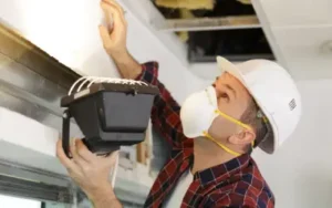 a portland homeowner checking for signs of asbestos in the walls
